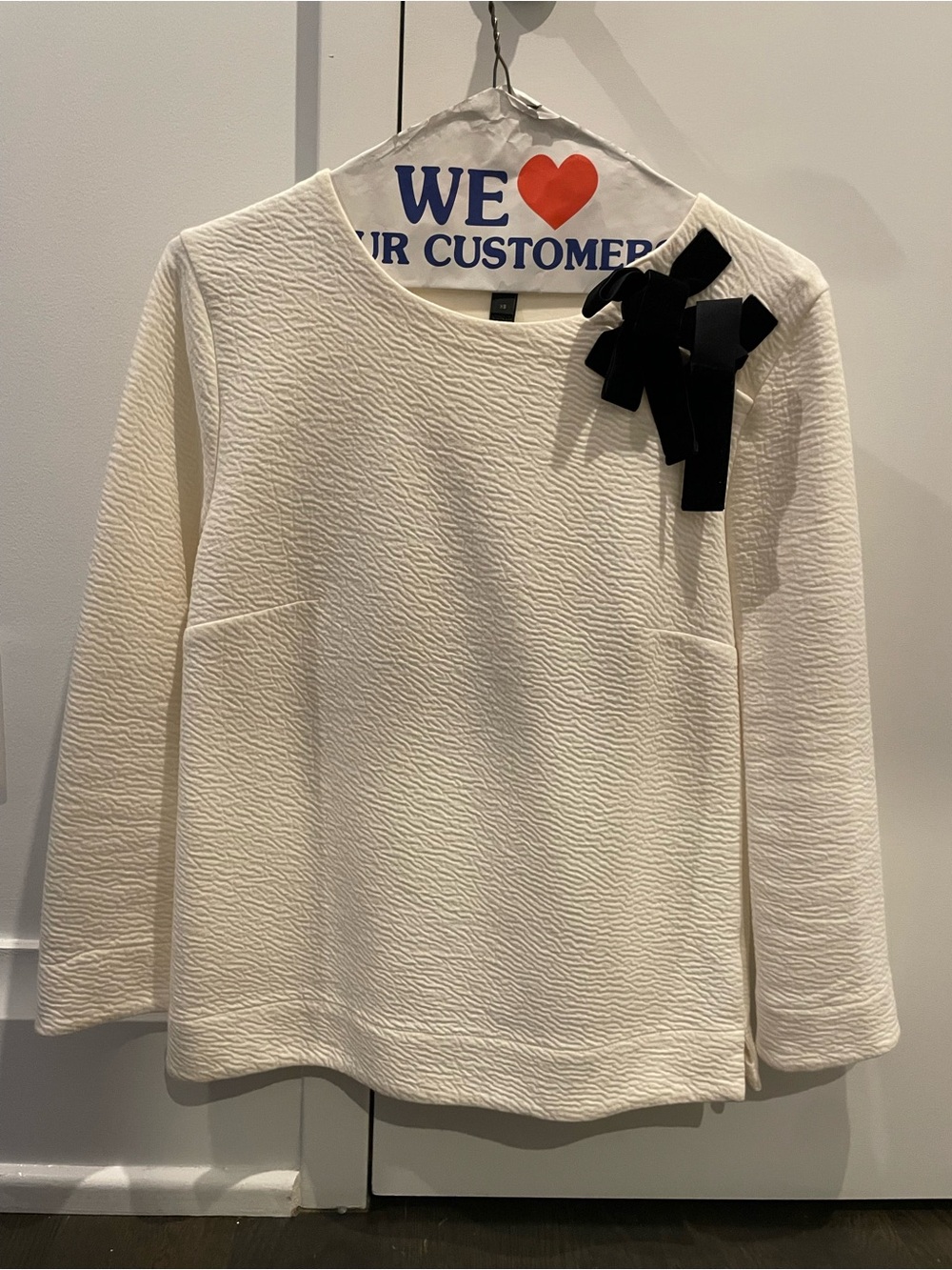 Cream Textured Long-Sleeve Top with Black Bow Accent